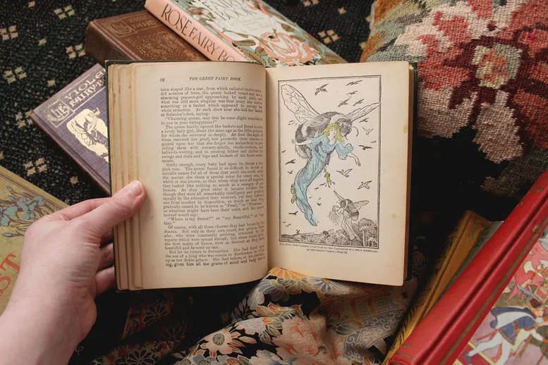 The Green Fairy Book, open to an illustration colored in with crayon